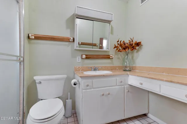 a white toilet sitting next to a bathroom sink