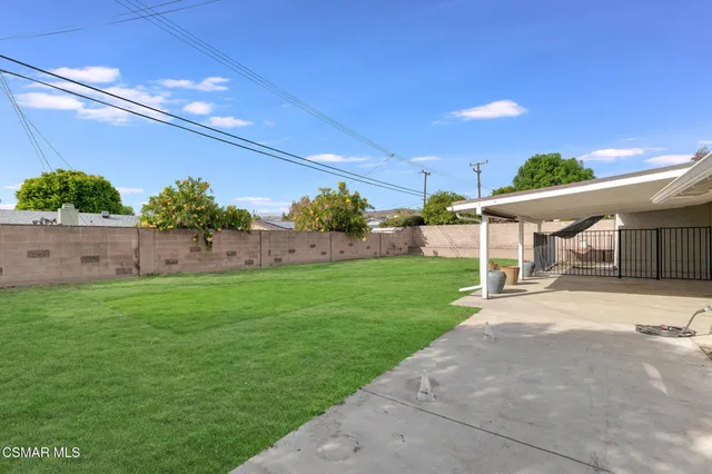 a view of house with backyard and a patio