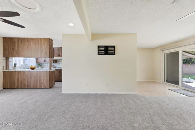 a view of room with window and ceiling fan