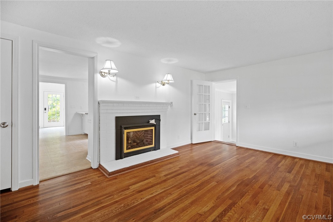 11252 Cauthorne Road Glen Allen, VA 23059 - Photo 5 of 45 a view of an empty room with wooden floor fireplace and a window