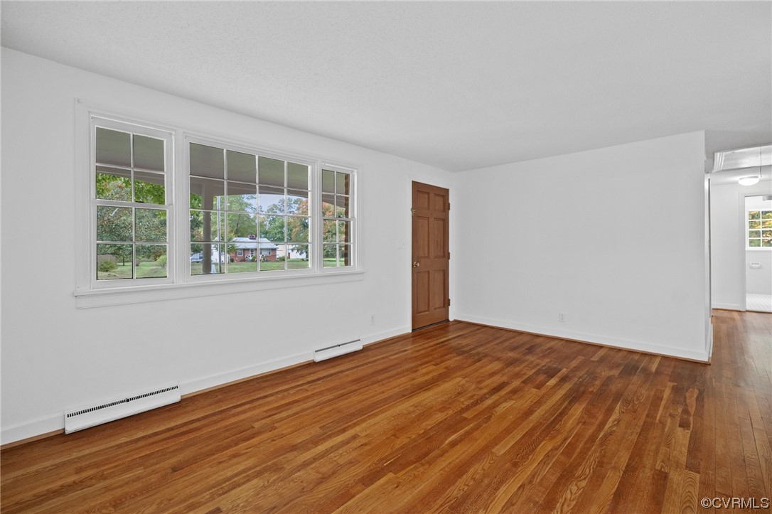 11252 Cauthorne Road Glen Allen, VA 23059 - Photo 6 of 45 a view of an empty room with wooden floor and a window