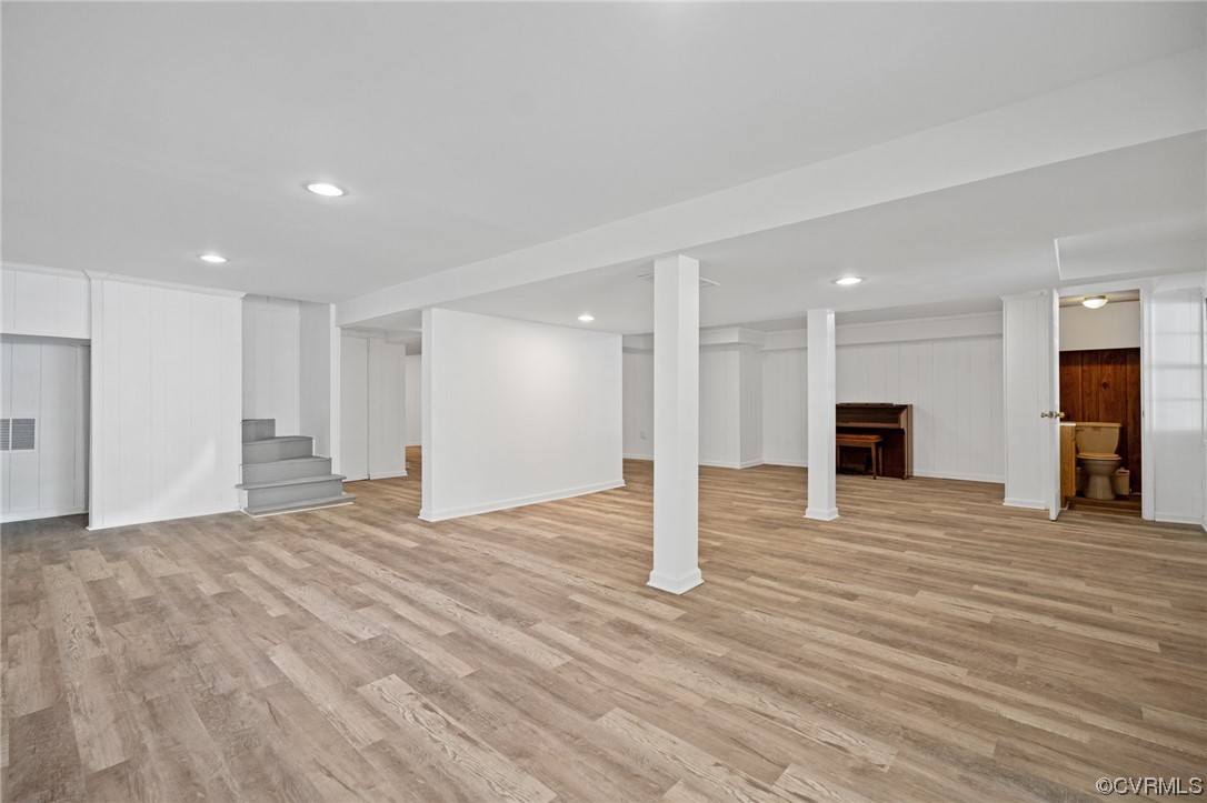 11252 Cauthorne Road Glen Allen, VA 23059 - Photo 7 of 45 a view of an empty room with wooden floor and kitchen space