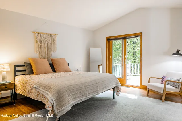 a bedroom with a bed chair and a window