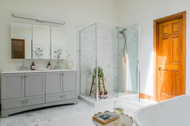 a bathroom with a double vanity sink and a window