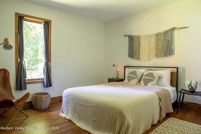 a bedroom with a bed and window