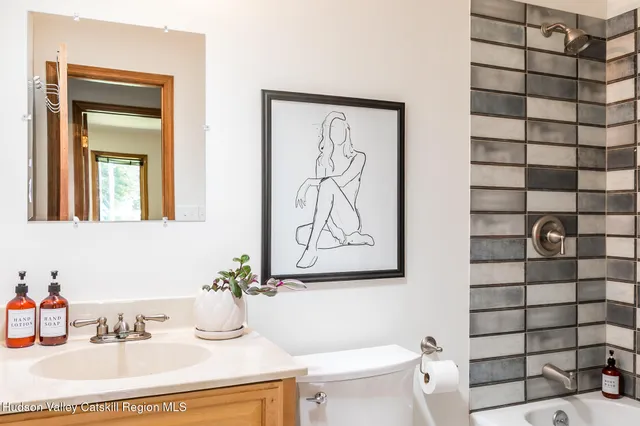 a bathroom with a sink a toilet and shower curtain