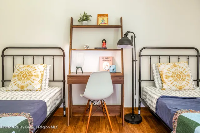 a bedroom with a bed and a lamp next to a window