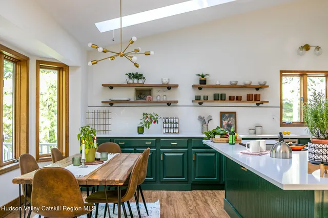 a kitchen with a table chairs stove and cabinets