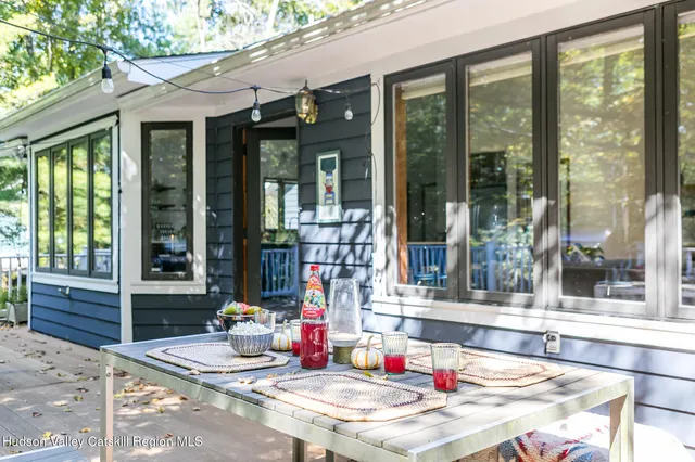 a living room with hard wood floor and a table and chairs