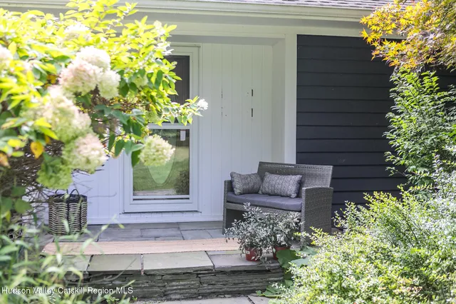 a view of a house with a yard and sitting area