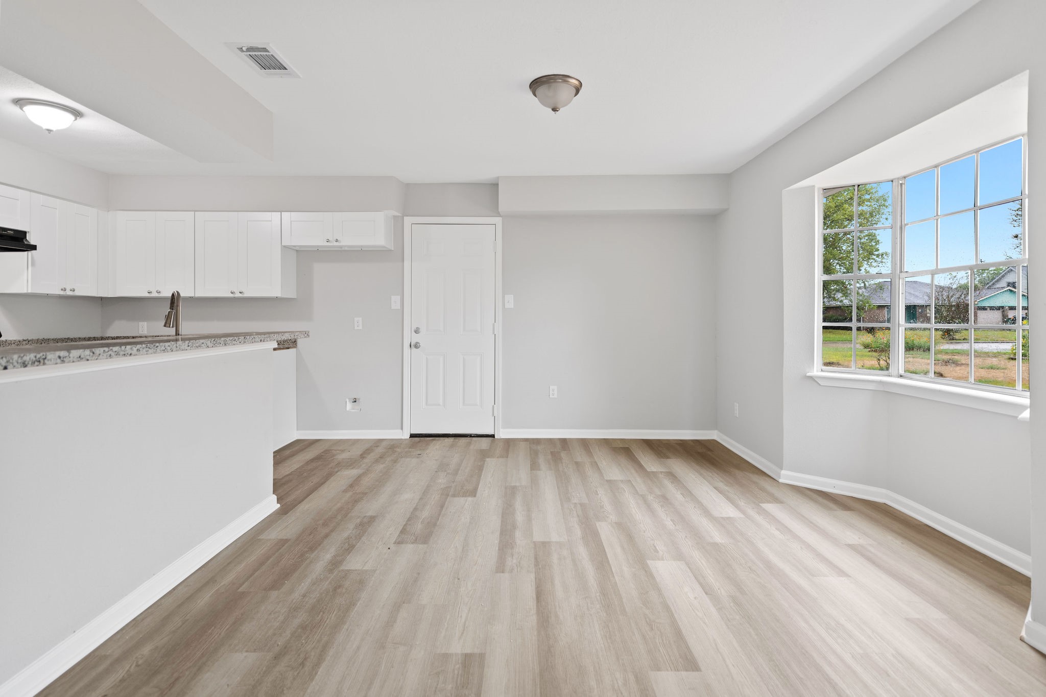 125 Bastrop Street Angleton, TX 77515 - Photo 12 of 18 a view of a kitchen with wooden floor and a window