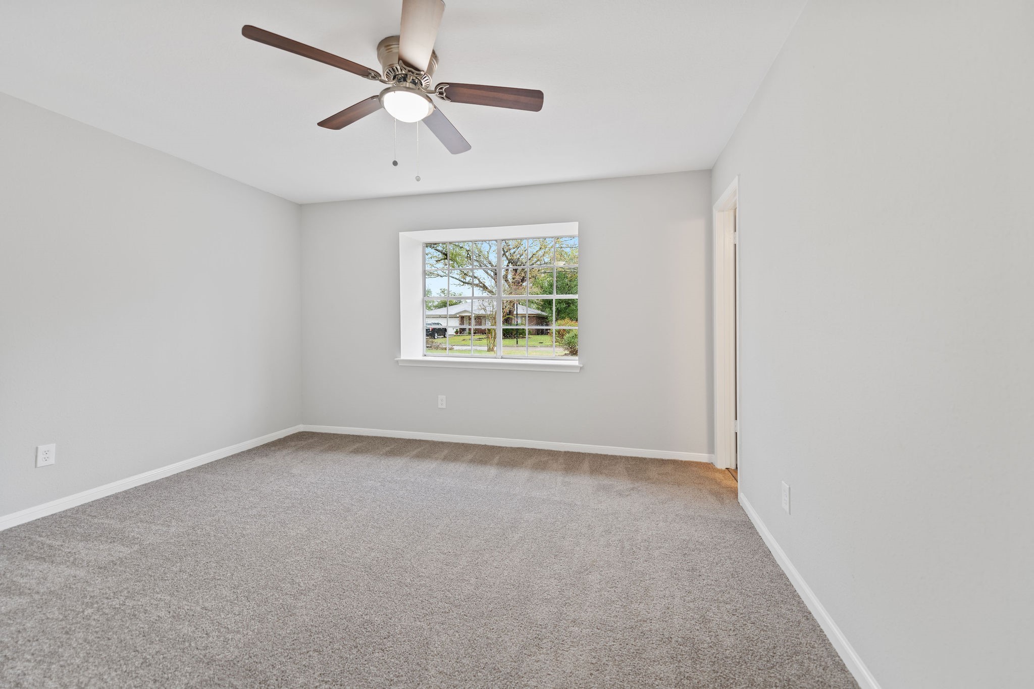 125 Bastrop Street Angleton, TX 77515 - Photo 16 of 18 an empty room with windows and fan
