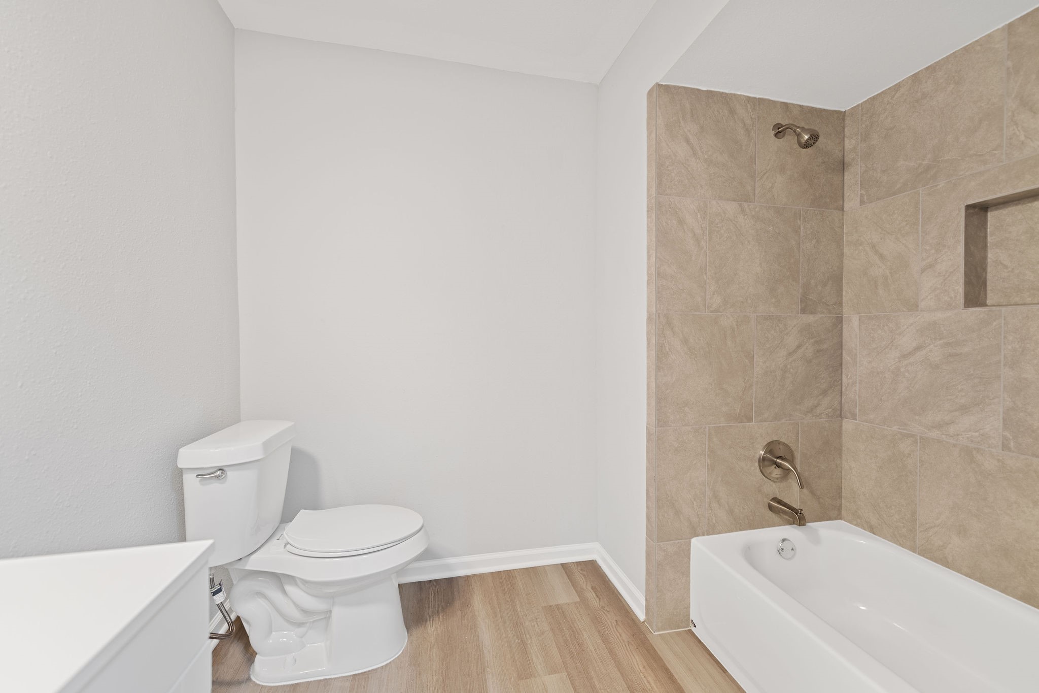 125 Bastrop Street Angleton, TX 77515 - Photo 17 of 18 a bathroom with a toilet and a bathtub