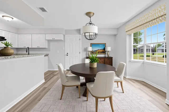 a view of a dining room with furniture window and wooden floor
