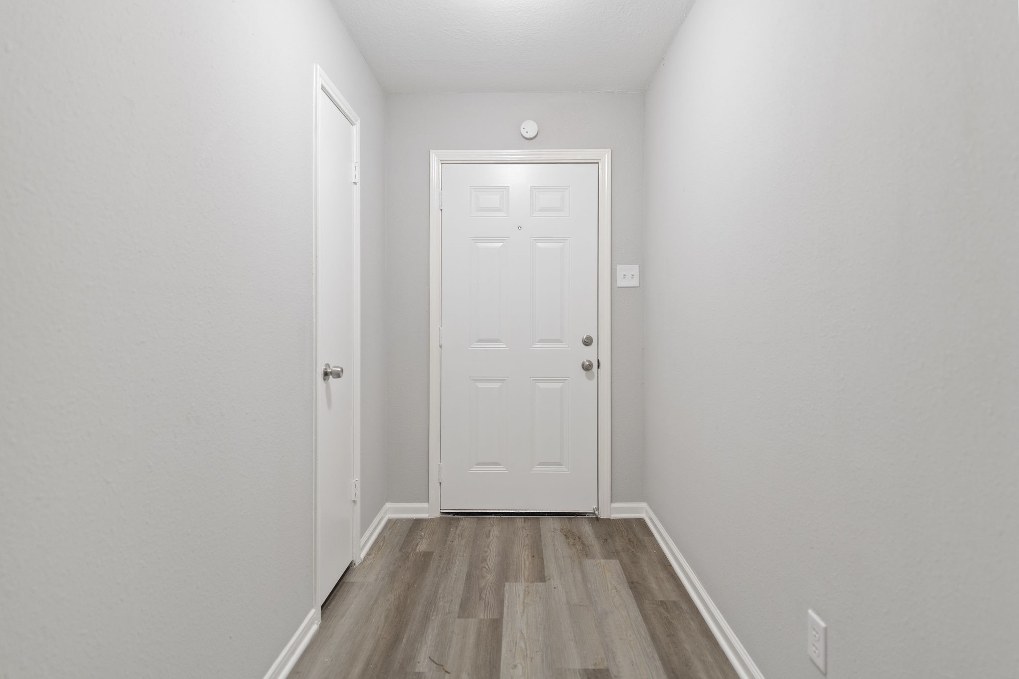 125 Bastrop Street Angleton, TX 77515 - Photo 5 of 18 a view of an empty room with wooden floor and a window