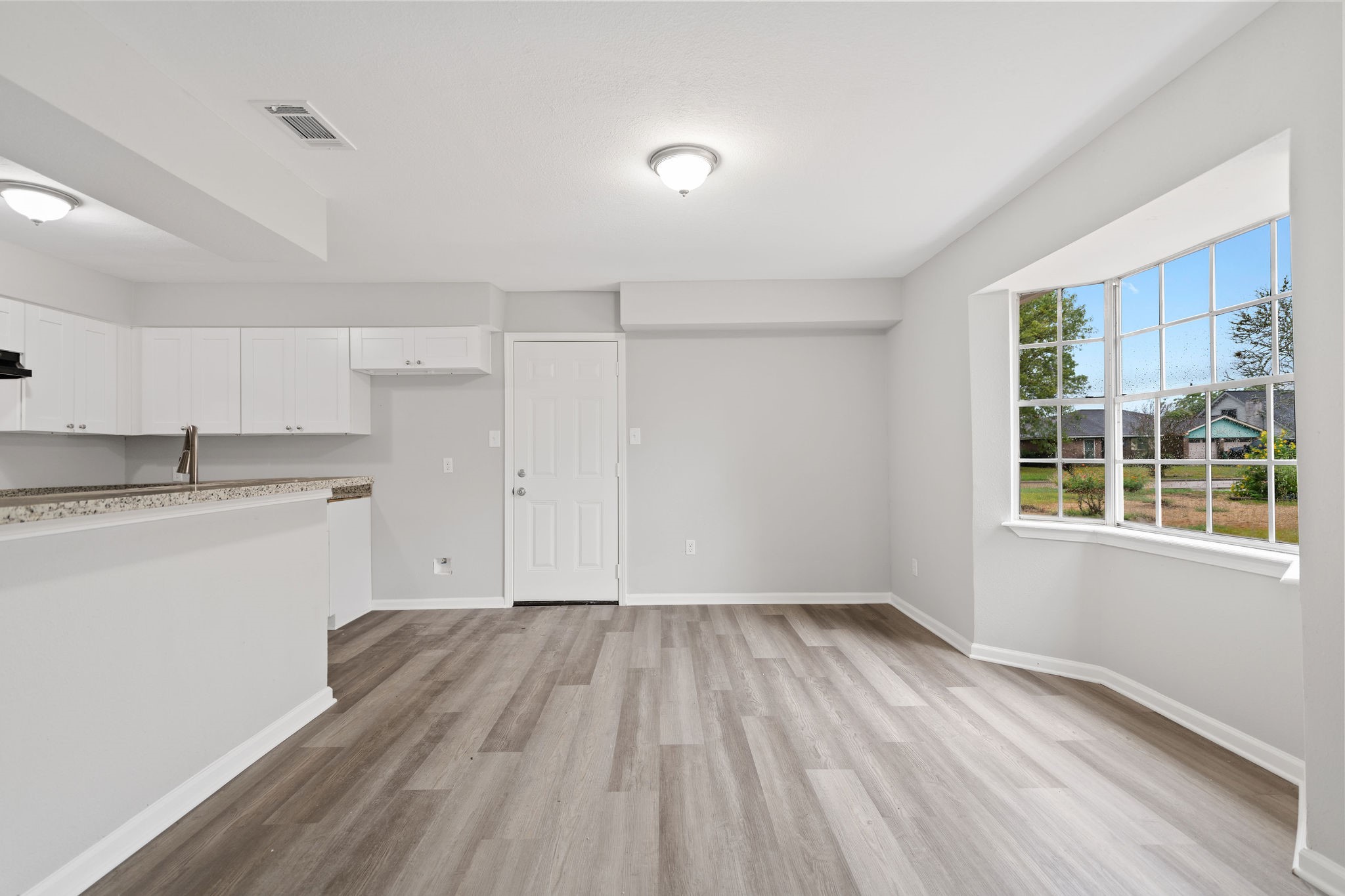 125 Bastrop Street Angleton, TX 77515 - Photo 7 of 18 a view of kitchen with wooden floor and electronic appliances