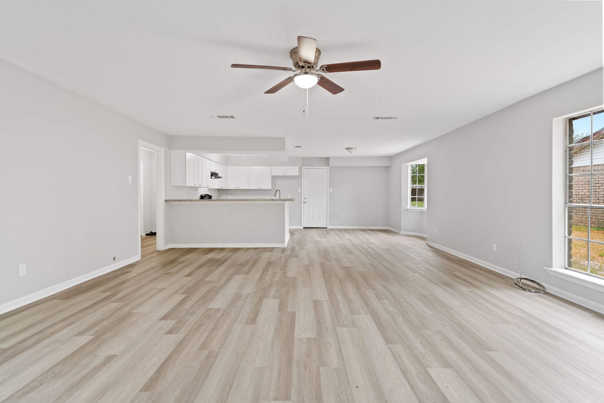 125 Bastrop Street Angleton, TX 77515 - Photo 8 of 18 a view of empty room with wooden floor and ceiling fan