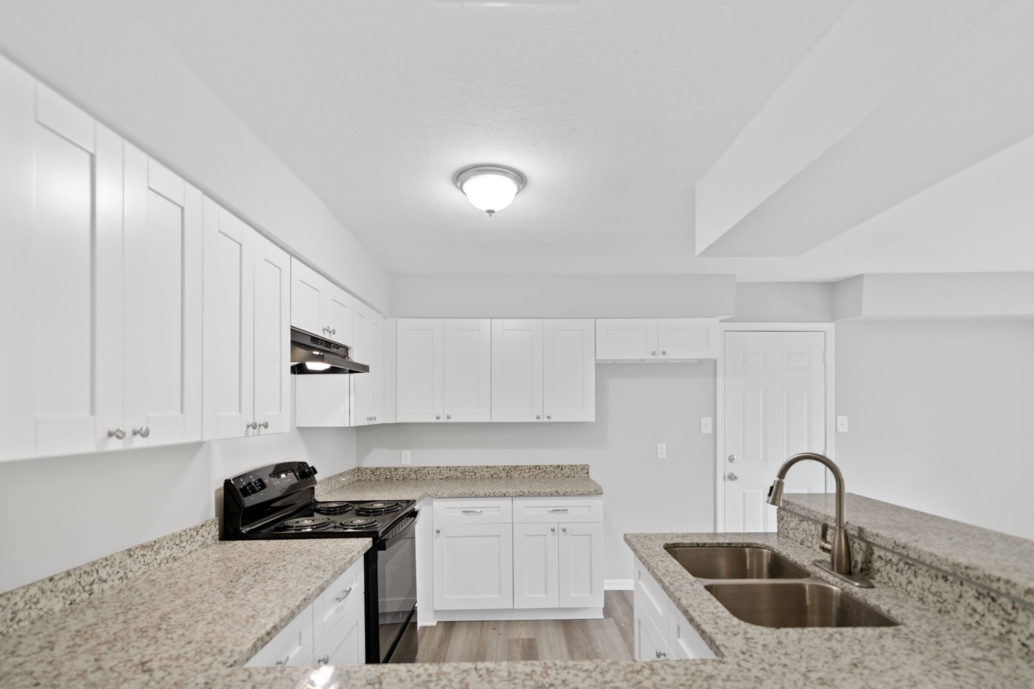 125 Bastrop Street Angleton, TX 77515 - Photo 9 of 18 a kitchen with granite countertop a sink a stove and cabinets