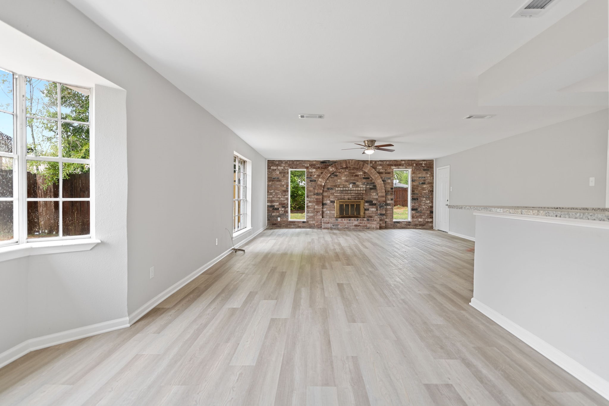 125 Bastrop Street Angleton, TX 77515 - Photo 10 of 18 a view of empty room with wooden floor and fan