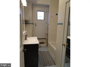 2349 South 11th Street, Unit 2 Philadelphia, PA 19148 - Photo 6 of 8 a bathroom with a sink and mirror