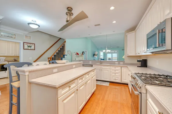 a kitchen with a stove a sink and a refrigerator