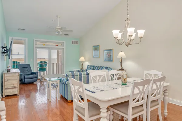 a view of a dining room with furniture wooden floor and chandelier