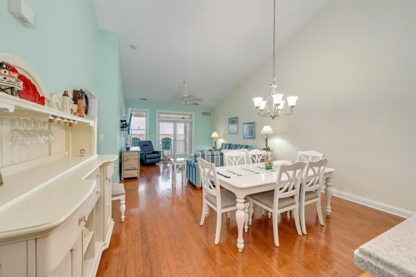a view of a dining room with furniture wooden floor and chandelier