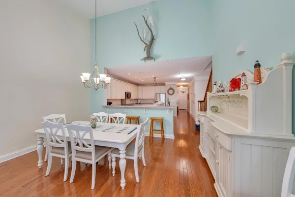 a view of a dining room with furniture and wooden floor