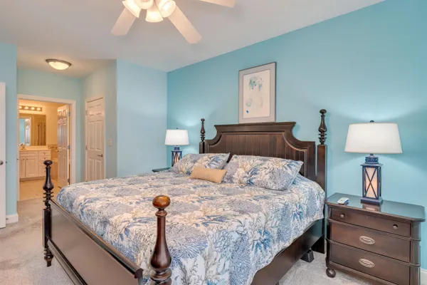 a bedroom with a bed and a lamp on table