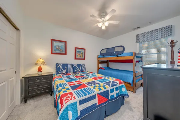 a bedroom that has a bed and a chandelier