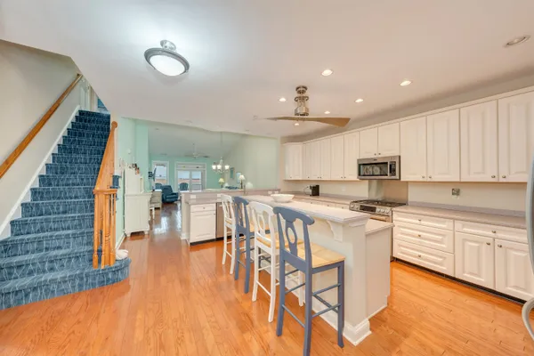 a kitchen with stainless steel appliances kitchen island granite countertop a stove a sink and a refrigerator