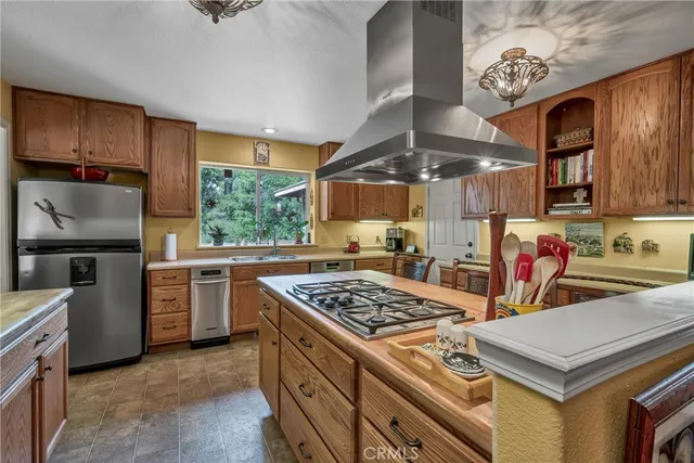 a kitchen with stainless steel appliances granite countertop a sink a stove and a microwave