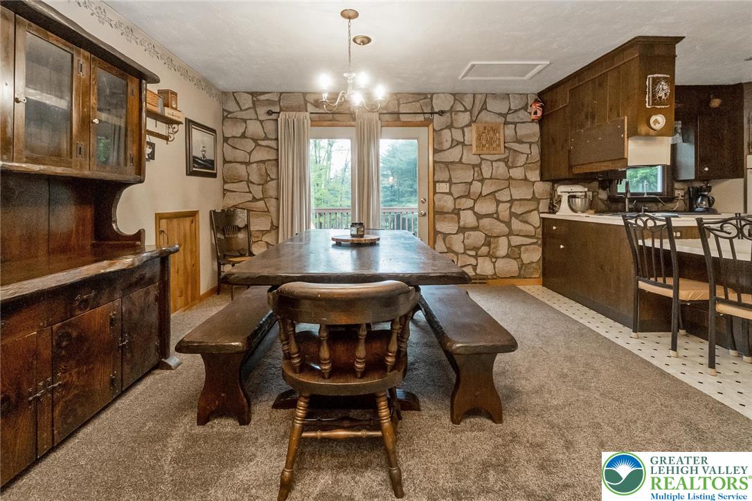 9223 North Loop Road Slatington, PA 18080 - Photo 37 of 60 a kitchen with a table chairs refrigerator and cabinets