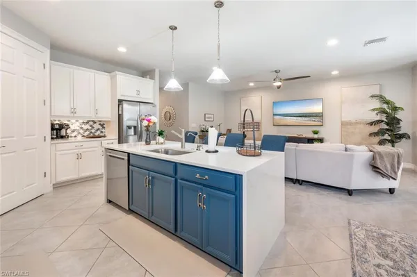 a kitchen with a sink stove and cabinets