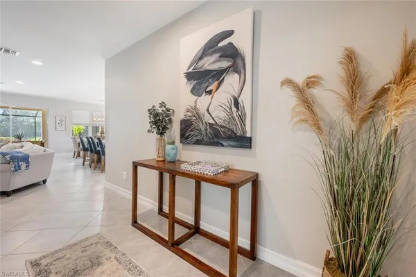 a living room with furniture and a painting on the wall