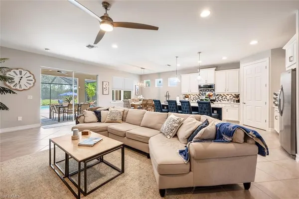 a living room with furniture and kitchen view