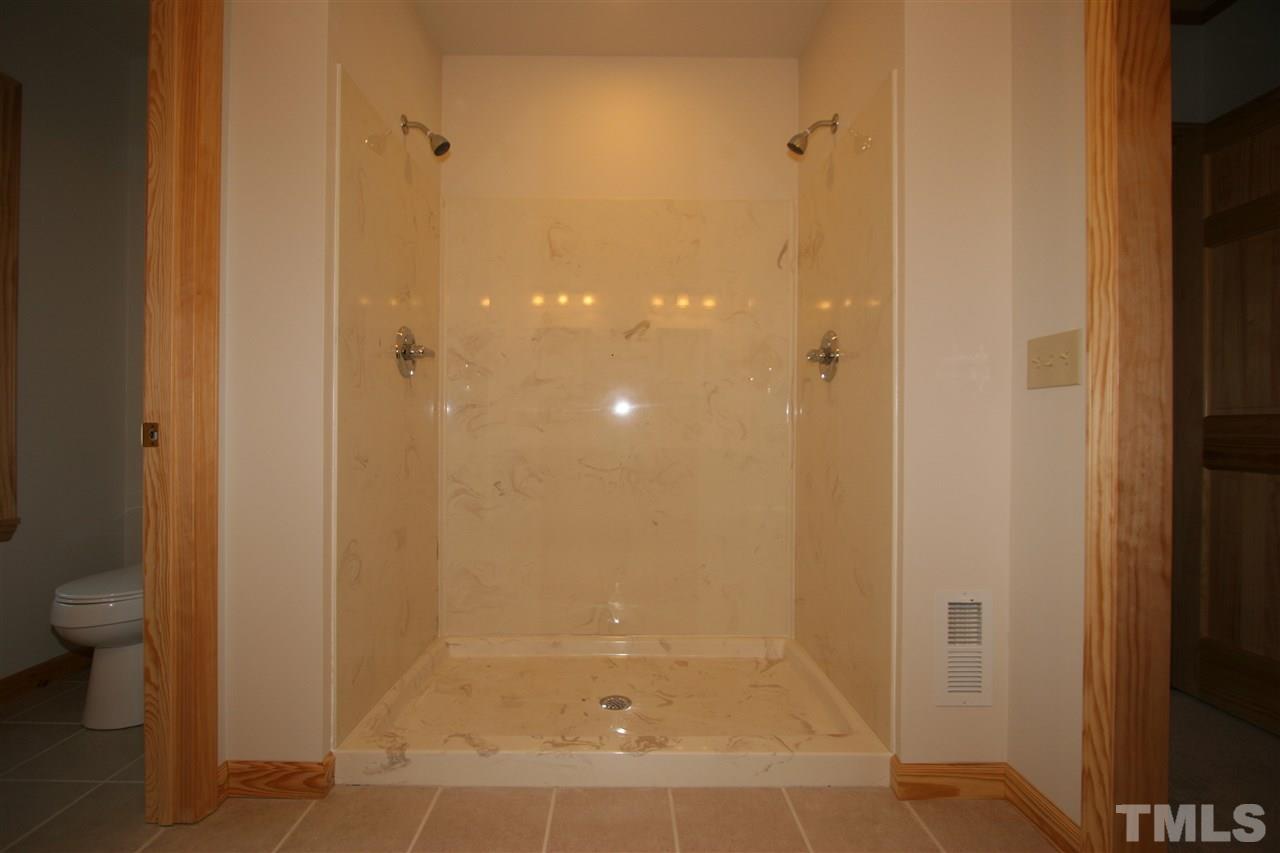 736 Highland Road Apex, NC 27523 - Photo 14 of 25 Low maintenance marble shower with two showerheads.