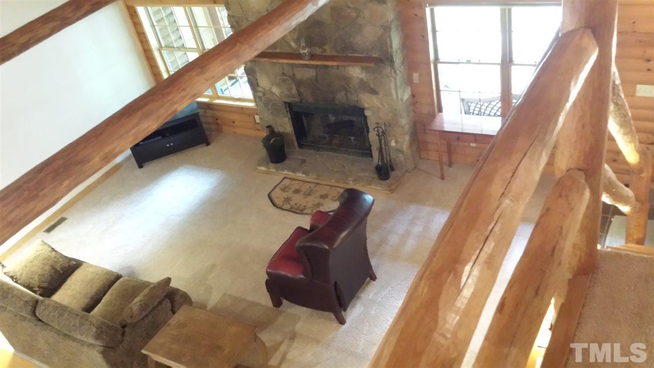 736 Highland Road Apex, NC 27523 - Photo 6 of 25 Living room has a wood burning fireplace insert and real stone surround.