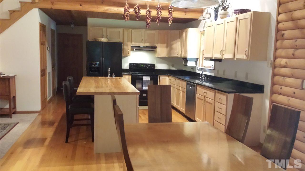 736 Highland Road Apex, NC 27523 - Photo 7 of 25 Maple cabinets, custom maple island and granite counter-tops in this kitchen.