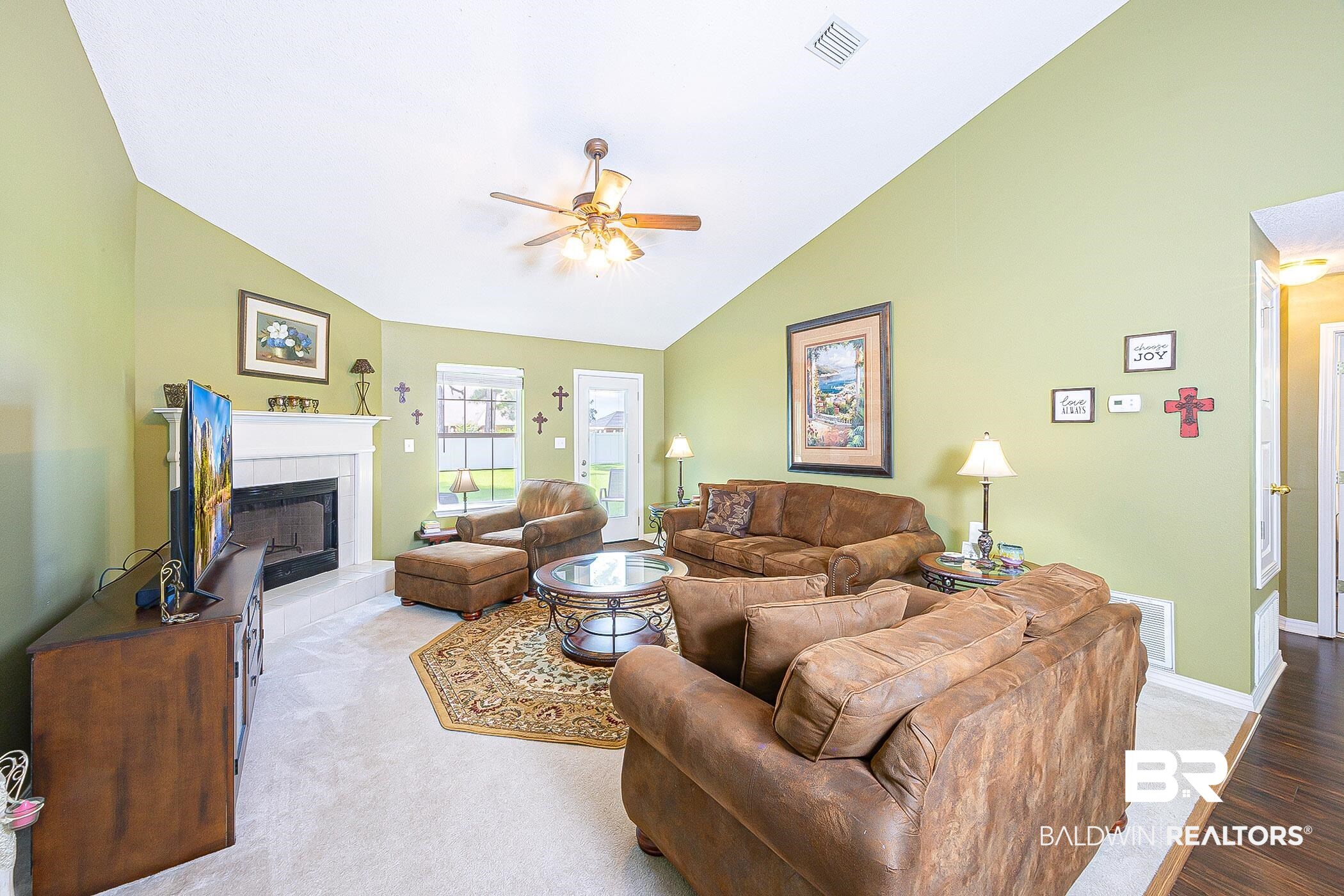 16154 Parke Boulevard Foley, AL 36535 - Photo 7 of 44 Spacious Living room featuring vaulted ceiling, fireplace and ceiling fan