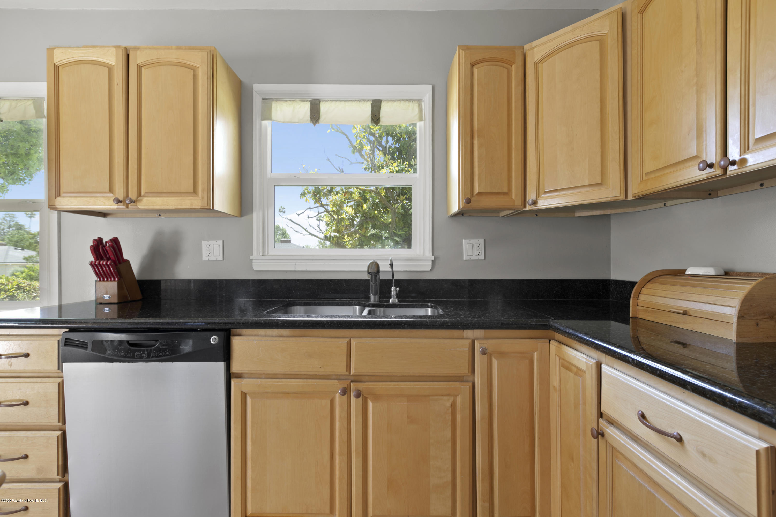 1231 Meadowbrook Road Altadena, CA 91001 - Photo 11 of 25 a kitchen with stainless steel appliances granite countertop a sink and a white cabinets