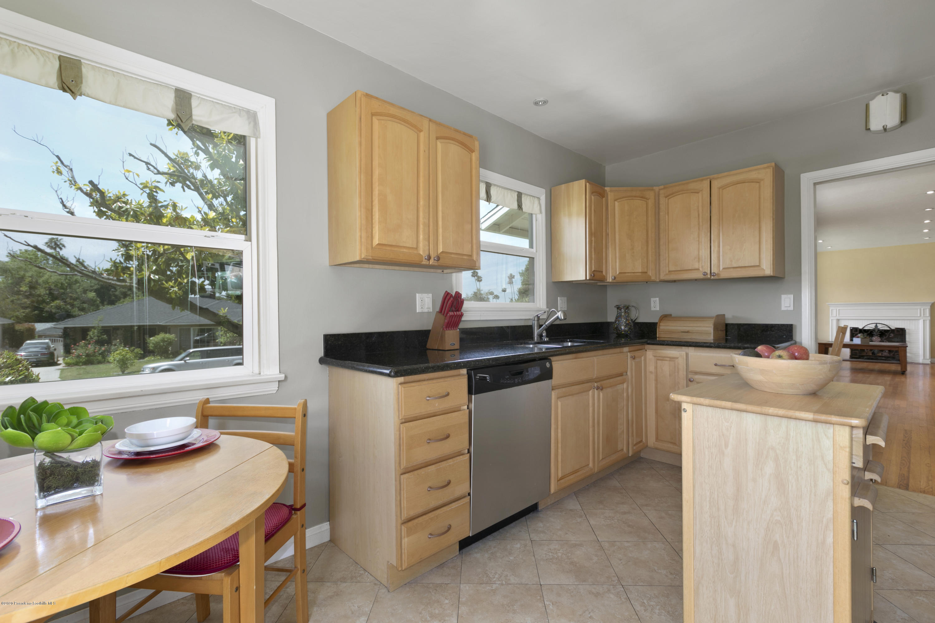 1231 Meadowbrook Road Altadena, CA 91001 - Photo 14 of 25 a kitchen with kitchen island granite countertop white cabinets and window