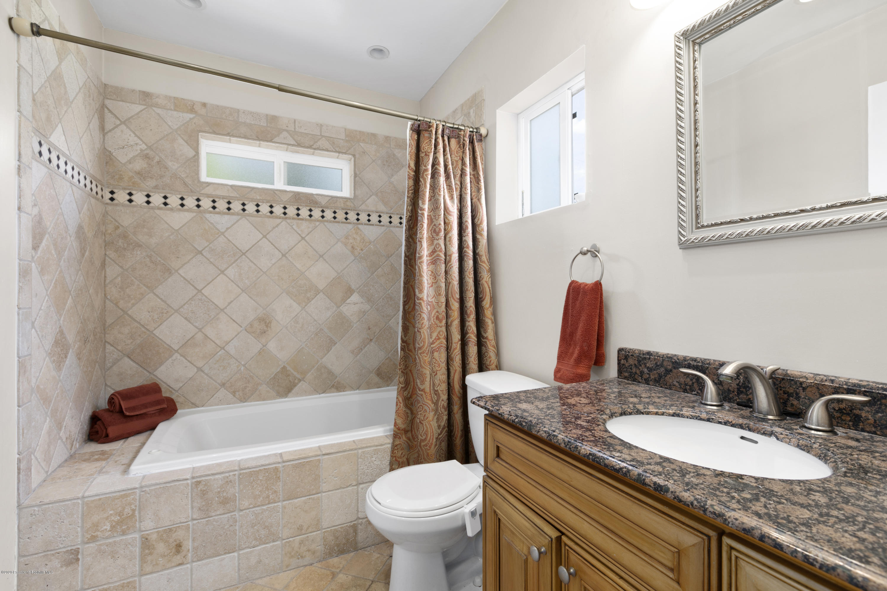 1231 Meadowbrook Road Altadena, CA 91001 - Photo 17 of 25 a bathroom with a granite countertop sink toilet and shower