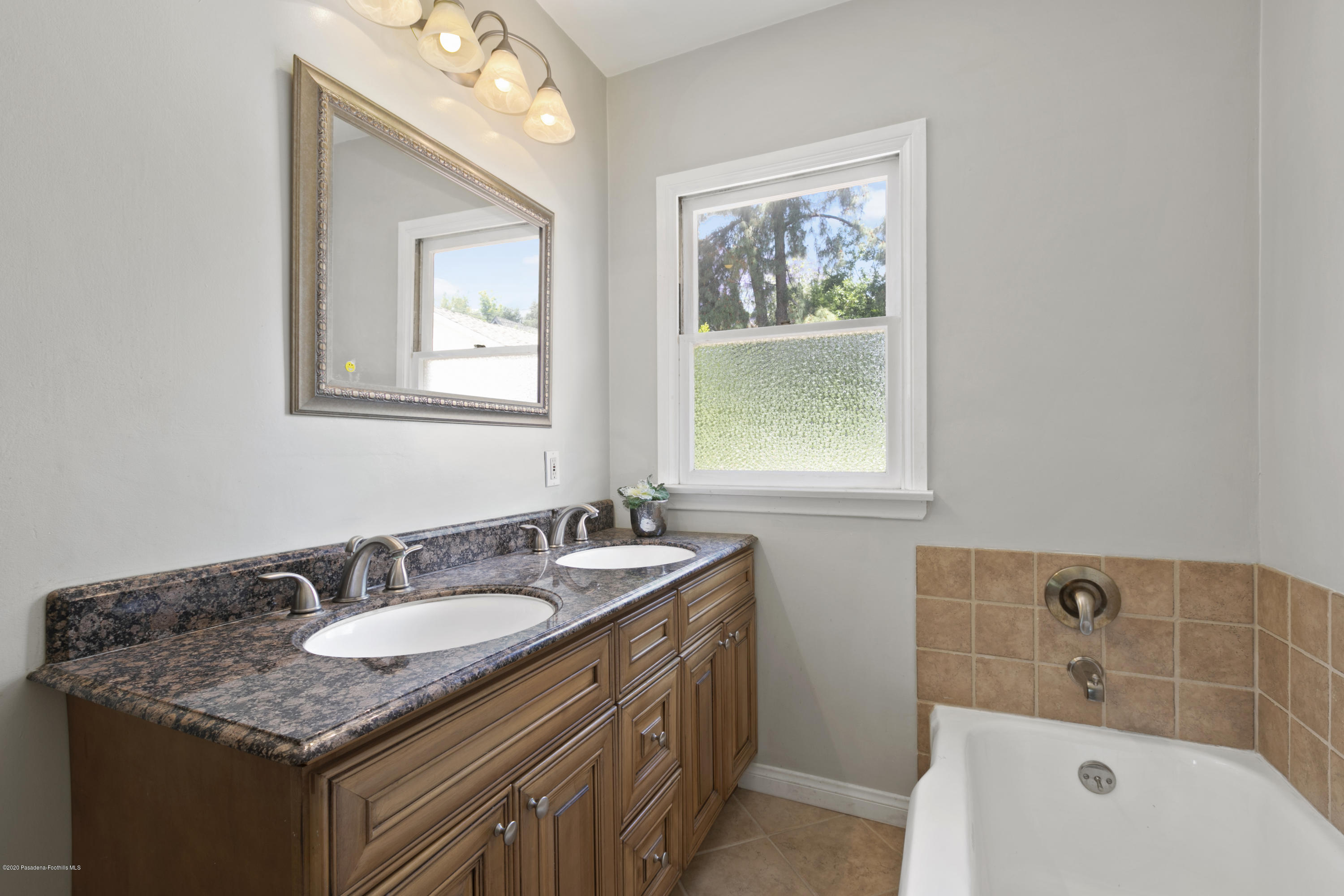 1231 Meadowbrook Road Altadena, CA 91001 - Photo 19 of 25 a bathroom with a granite countertop sink mirror and a bathtub