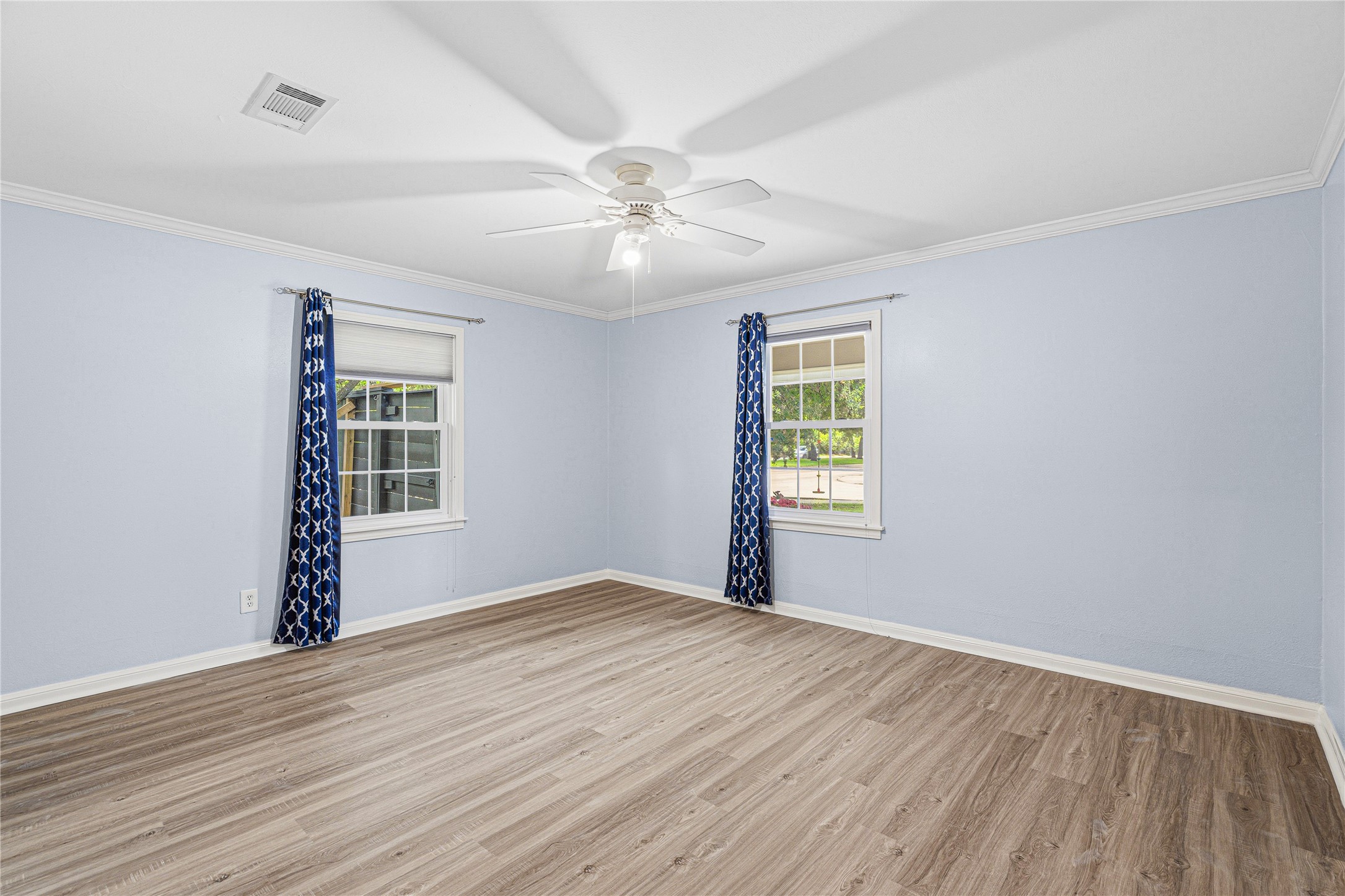 4002 Merrick Street Houston, TX 77025 - Photo 6 of 22 a view of an empty room with wooden floor and a window