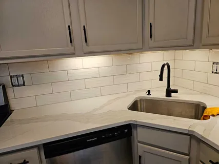 a kitchen with a sink and cabinets