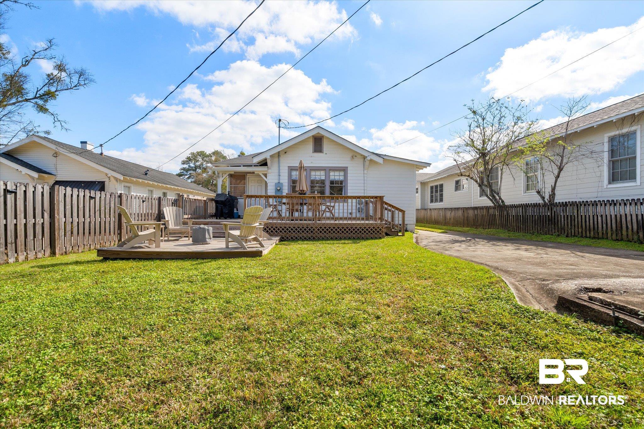 55 Silverwood Street Mobile, AL 36607 - Photo 26 of 31 Back of house featuring a yard, a deck, and fence private yard