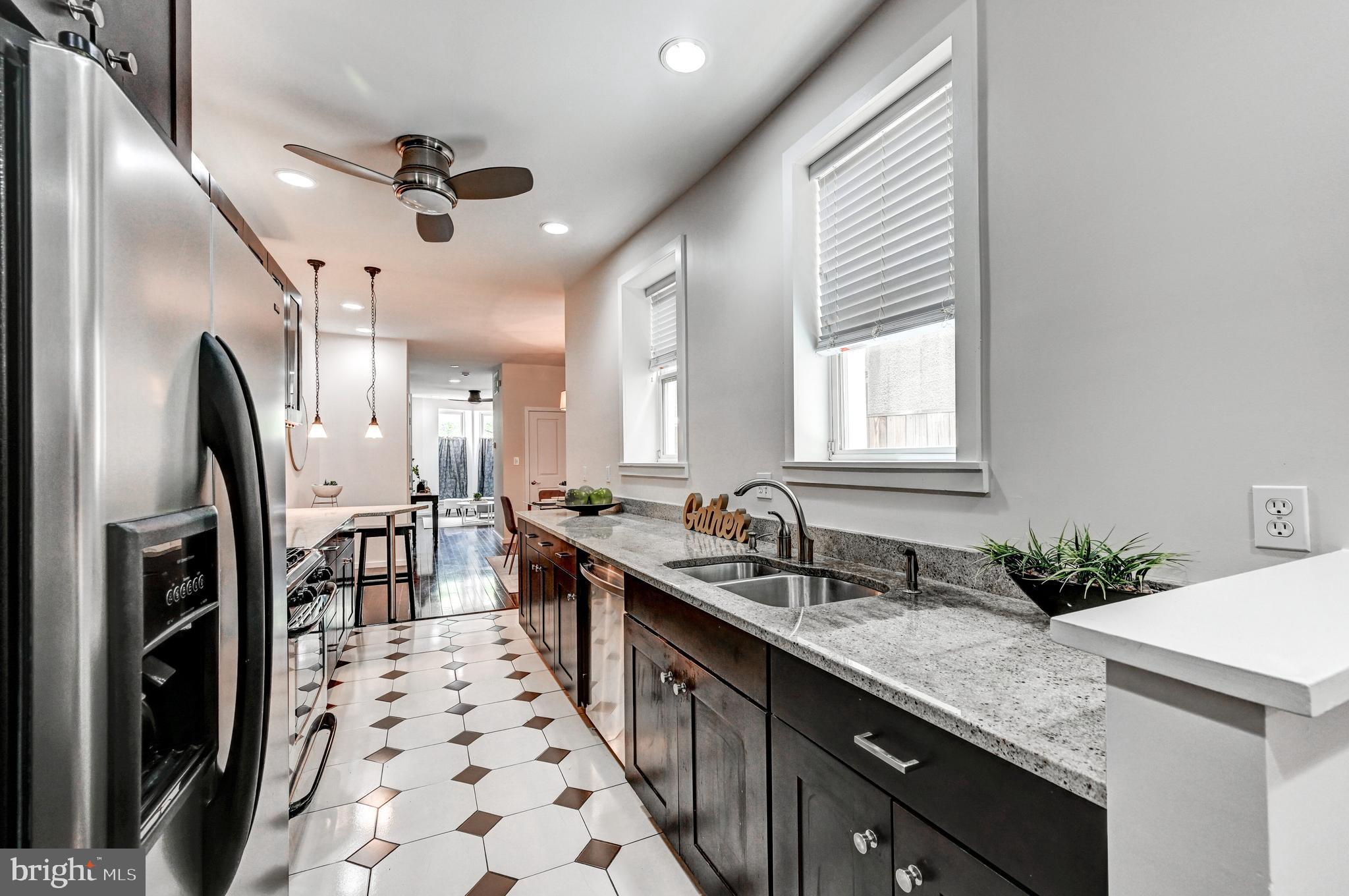136 West Ostend Street Baltimore, MD 21230 - Photo 12 of 33 a kitchen with granite countertop a sink appliances cabinets and furniture