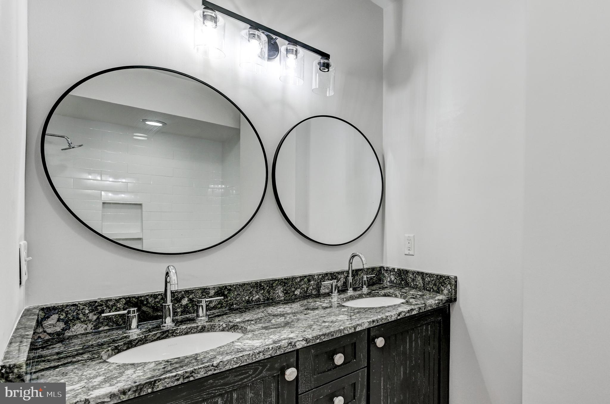 136 West Ostend Street Baltimore, MD 21230 - Photo 17 of 33 a bathroom with a sink and a mirror