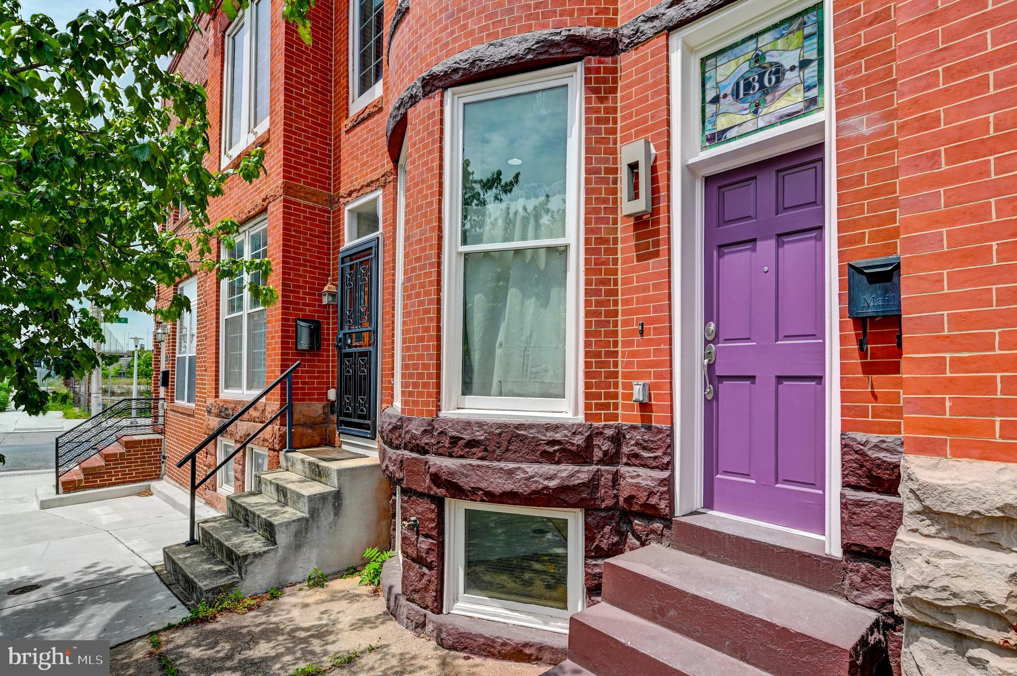 136 West Ostend Street Baltimore, MD 21230 - Photo 2 of 33 a front view of a house with a yard